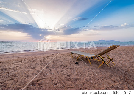 Lonely sunbed on beach 63611567