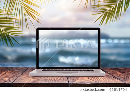 Notebook display with blurred sea background. 63611704