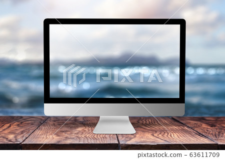 Computer display with blurred sea background. 63611709