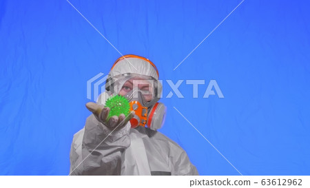 Doctor in respirator show a virus model. Slow motion. Woman wearing protect medical aerosol spray paint mask. Green ball spike thorn. Doctor in respirator show a virus model. Slow motion. Woman wearing protect medical aerosol spray paint mask. Green ball spike thorn. 63612962