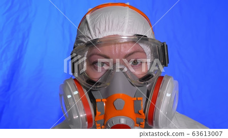 Scientist virologist in respirator. Woman close up look, wearing protective medical mask. Concept health safety N1H1 coronavirus epidemic 2019 nCoV. 63613007