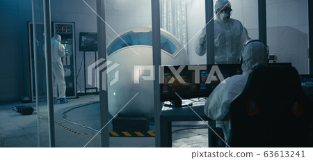 Engineers working in clean room Engineers working in clean room 63613241