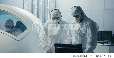 Engineers discussing and assembling in clean room 63613255