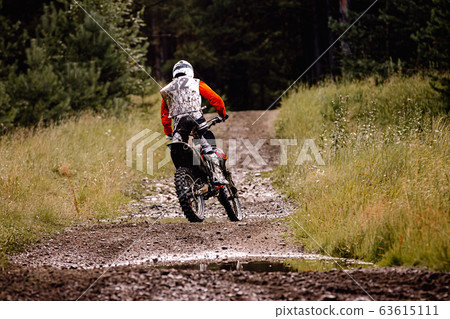 back enduro racer riding a dirty trail back enduro racer riding a dirty trail 63615111