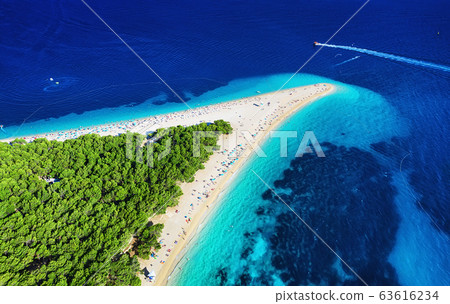 Croatia, Hvar island, Bol. Panoramic aerial view at the Zlatni Rat. Beach and sea from air. Croatia, Hvar island, Bol. Panoramic aerial view at the Zlatni Rat. Beach and sea from air. 63616234
