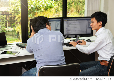 Programmers team working in a software developing. Programmers team working in a software developing. 63616273