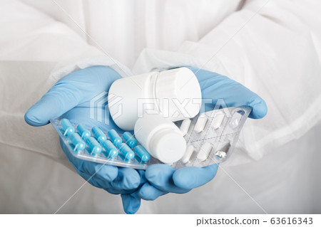 Closeup of hands in gloves with tablets Closeup of hands in gloves with tablets 63616343