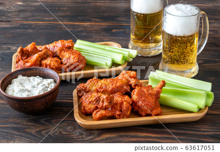Buffalo wings with mugs of beer Buffalo wings with mugs of beer 63617051