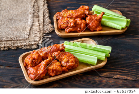 Buffalo wings with fresh celery stalks Buffalo wings with fresh celery stalks 63617054