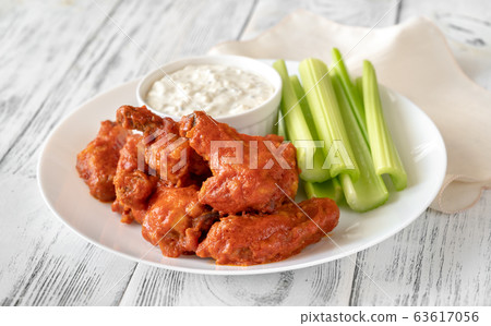 Bowl of buffalo wings with blue cheese dip Bowl of buffalo wings with blue cheese dip 63617056