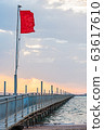 Red flag flying on pontoon bridge 63617610