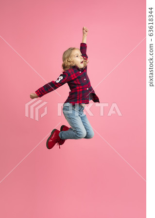 Caucasian little girl's portrait on pink studio background Caucasian little girl's portrait on pink studio background 63618344
