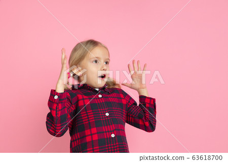 Caucasian little girl's portrait on pink studio background Caucasian little girl's portrait on pink studio background 63618700