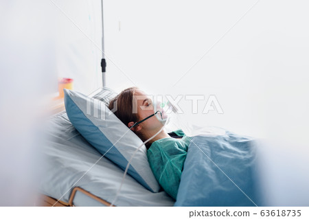 Infected patient in quarantine lying in bed in hospital, coronavirus concept. Infected patient in quarantine lying in bed in hospital, coronavirus concept. 63618735