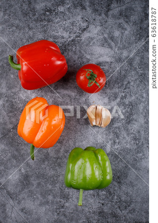 Color bell peppers on a blue background. Top view. Color bell peppers on a blue background. Top view. 63618787