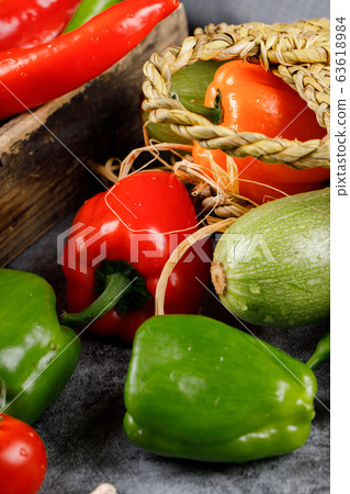 Color sweet peppers in a rustic basket. 63618984