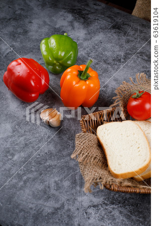 Colorful peppers and thin bread slices. Colorful peppers and thin bread slices. 63619104