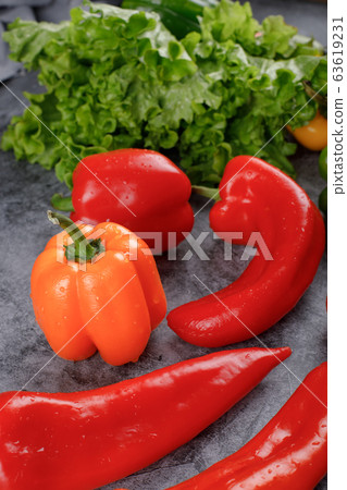 Yellow bell pepper with red chilies and lettuce. 63619231