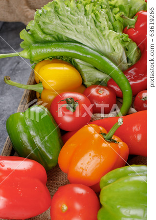Colorful bell peppers with greenery. Top view. Colorful bell peppers with greenery. Top view. 63619266