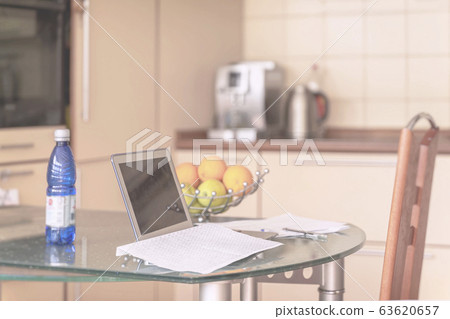 Laptop in kitchen interior, open documents, remote working from home. Freelance workplace in kitchen with notebook. freelance, quarantine, distance learning, study. Laptop in kitchen interior, open documents, remote working from home. Freelance workplace in kitchen with notebook. freelance, quarantine, distance learning, study. 63620657