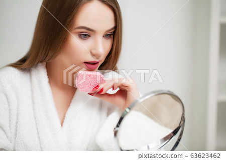 Pretty girl wipes the face after taking a shower sponge Pretty girl wipes the face after taking a shower sponge 63623462