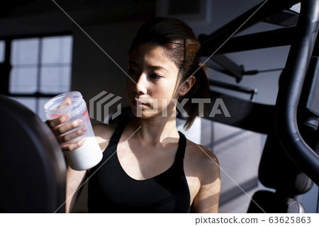  Woman drinking protein 63625863