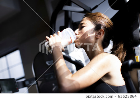  Woman drinking protein 63625864
