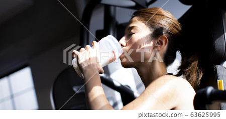  Woman drinking protein 63625995