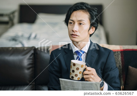 Businessman drinking coffee in room Businessman drinking coffee in room 63626567