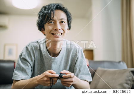 Men playing games in the room Men playing games in the room 63626635