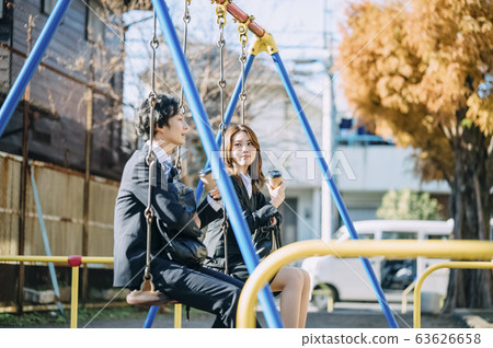 Businessman and businesswoman drinking coffee in park 63626658
