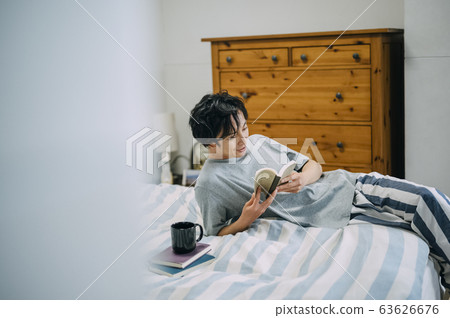 A man reading in the room 63626676