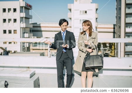 Businessman and businesswoman on the rooftop 63626696