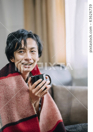 A man relaxing in the room 63626739