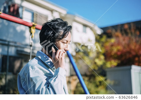 Businessman making a phone call in the park Businessman making a phone call in the park 63626846