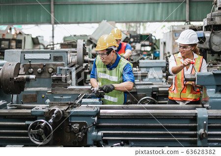 Teamwork professional engineer work heavy industry in factory. Teamwork professional engineer work heavy industry in factory. 63628382