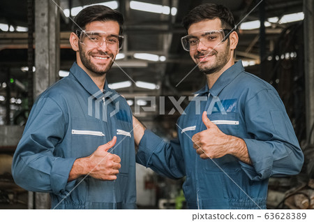 happy engineer men wearing uniform safety in factory relax time working. happy engineer men wearing uniform safety in factory relax time working. 63628389