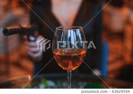 Glass of alcohol close up. 63629594