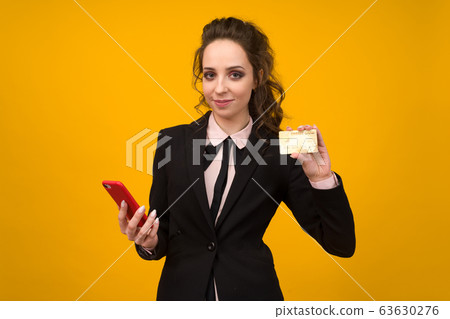 Photo of pleased young woman posing isolated over Photo of pleased young woman posing isolated over 63630276
