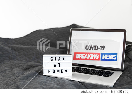 Lightbox with Stay home text on wooden background. Top view flat lay Covid-19 quote 63630502