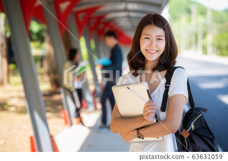 Asian student girl stand with group of happy teen 63631059