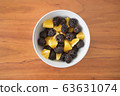 Cut orange and blackberry in gray tableware 63631074