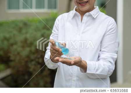 Old people in asia usd alcohol gel cleaning her 63631088