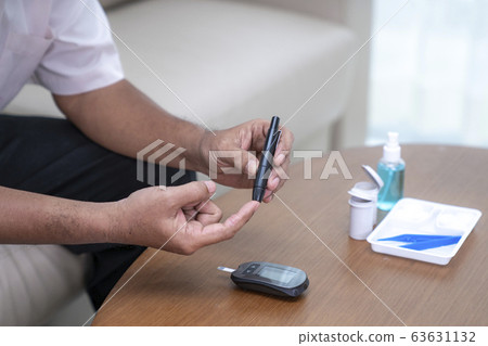 Asian old man test diabetes check by him self 63631132