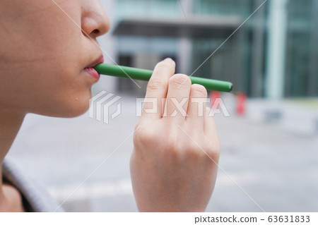 Young business woman smoking electronic taco Young business woman smoking electronic taco 63631833