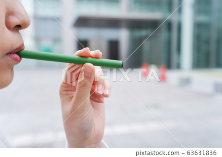 Young business woman smoking electronic taco 63631836