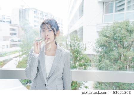 Young business woman smoking electronic taco Young business woman smoking electronic taco 63631868