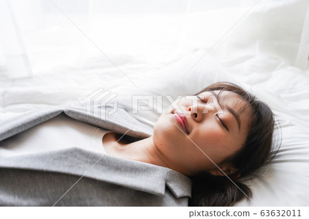 Young business woman taking a nap during work Young business woman taking a nap during work 63632011