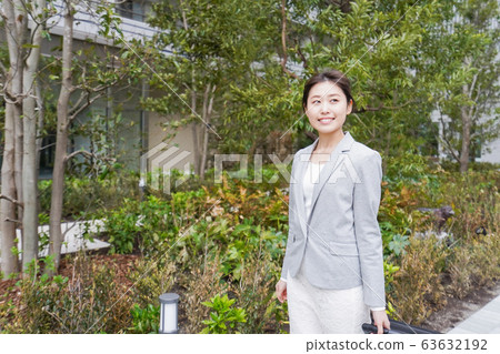 Young business woman walking in office city Young business woman walking in office city 63632192
