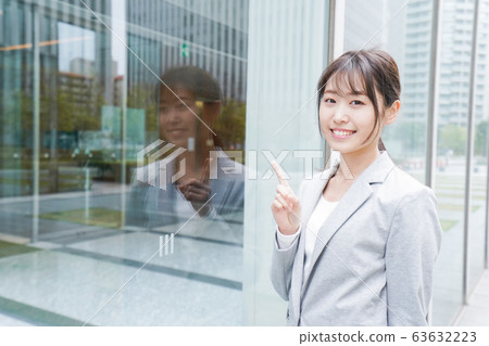 Young business woman walking in office city Young business woman walking in office city 63632223